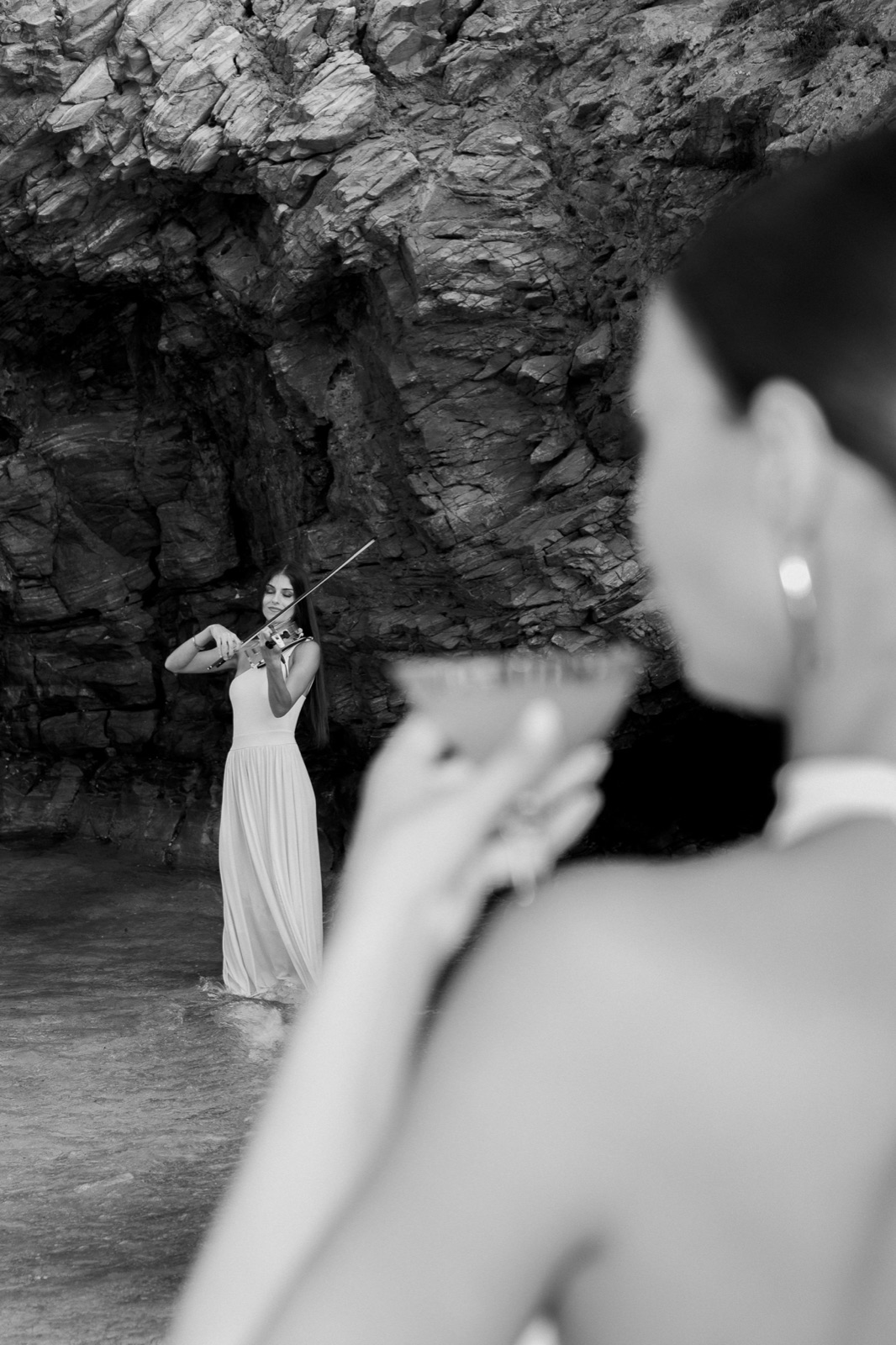 Black and white performance viewed past guests raising a toast