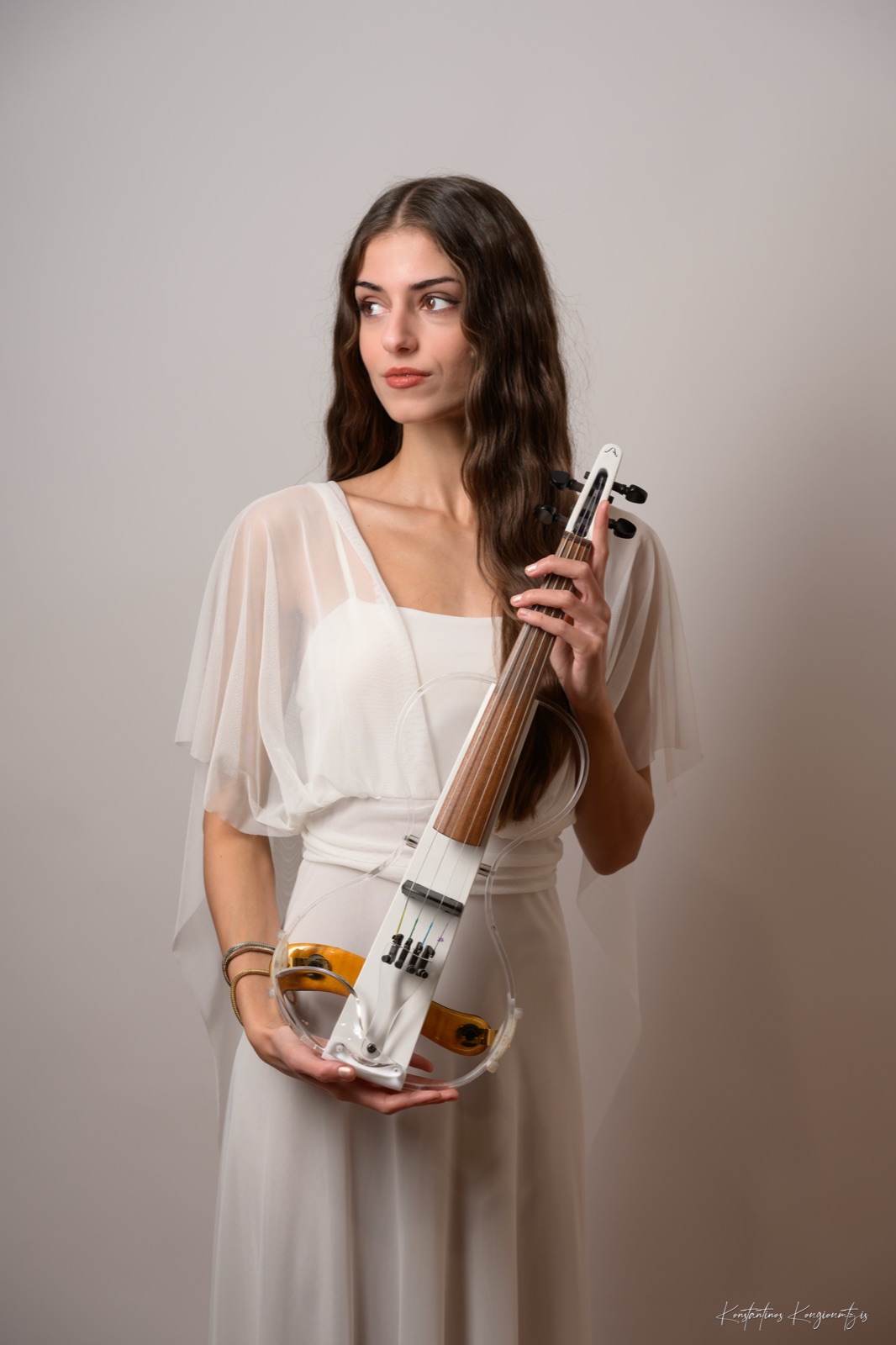 Studio portrait of Marvi holding her electric violin
